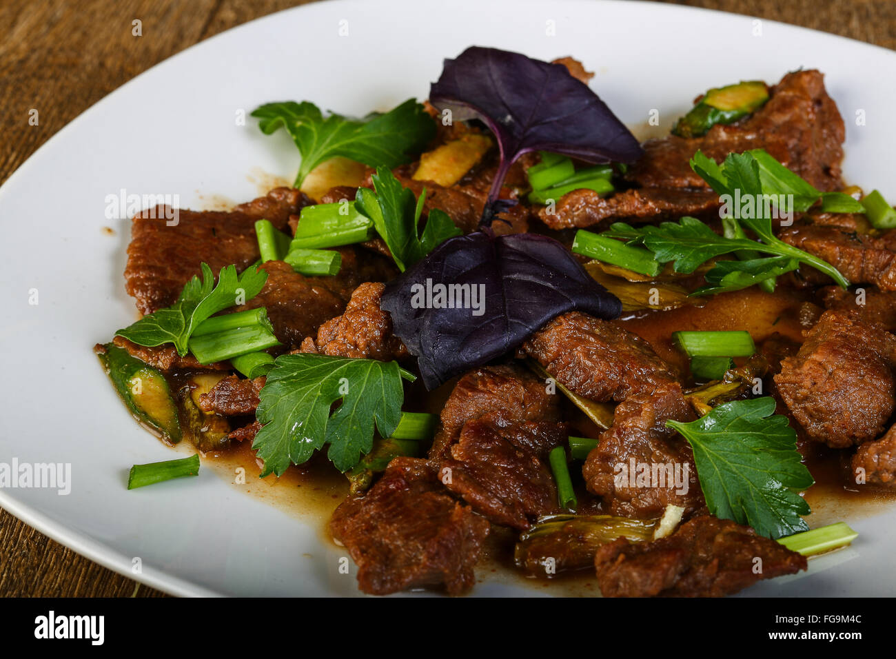Stirfry meat with coriander leaves Stock Photo Alamy