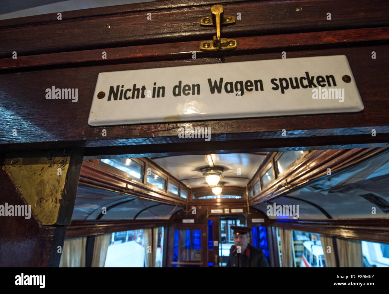 A sign reading 'Nicht in den Wagen spucken' (lit. 'Do not spit in the car') in the Merseburg overland railway from 1912 the tram museum in Halle, Germany, 18 February 2016. Halle is known as a pioneering city in the tram history with the first electrical tram network in Europe, having been erected in 1891. In the central station, the exhibition '125 Jahre elektrisiert durch Halle (Saale)' (lit. '125 years electrified through Halle') is opening tonight. PHOTO: HENDRICK SCHMIDT/dpa Stock Photo