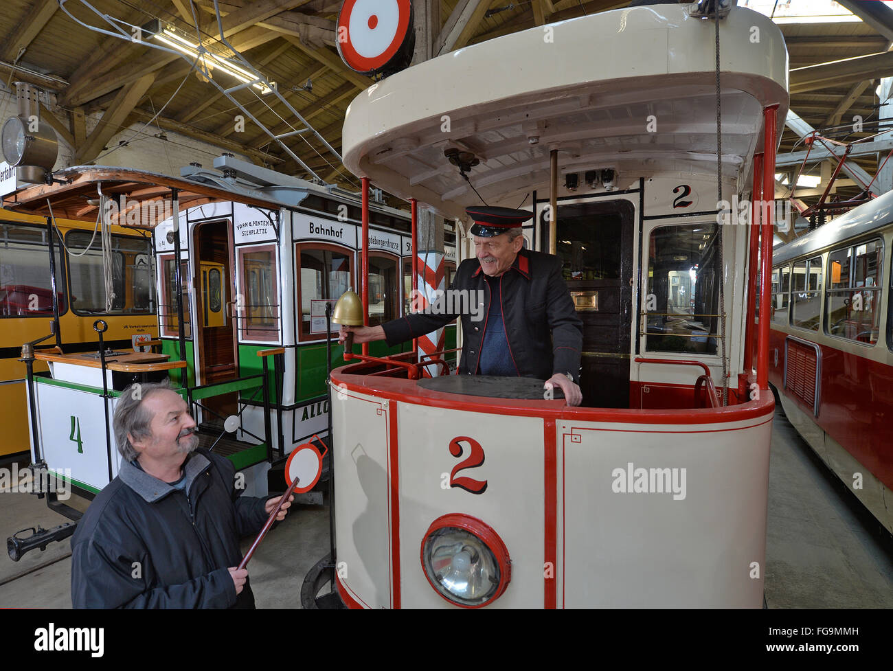 Harald Mey and Manfred Schumann standing in a historical railcar of the MAN machine works Augsburg from 1911 in the tram museum in Halle, Germany, 18 February 2016. Halle is known as a pioneering city in the tram history with the first electrical tram network in Europe, having been erected in 1891. In the central station, the exhibition '125 Jahre elektrisiert durch Halle (Saale)' (lit. '125 years electrified through Halle') is opening tonight. PHOTO: HENDRICK SCHMIDT/dpa Stock Photo