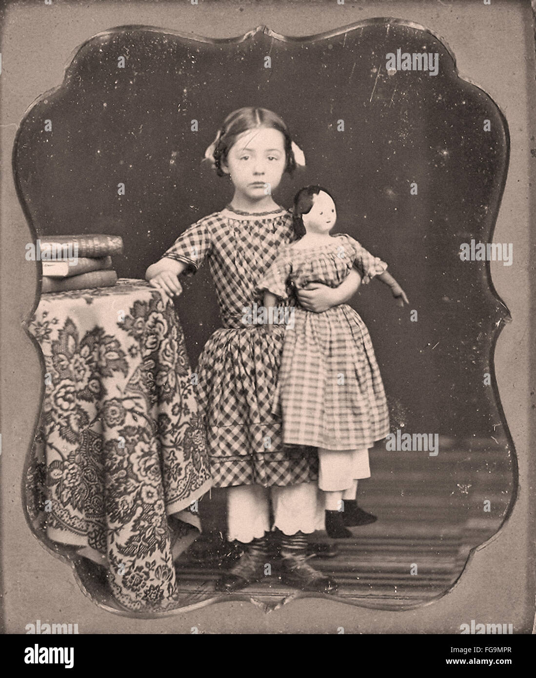 Young girl with her doll Stock Photo