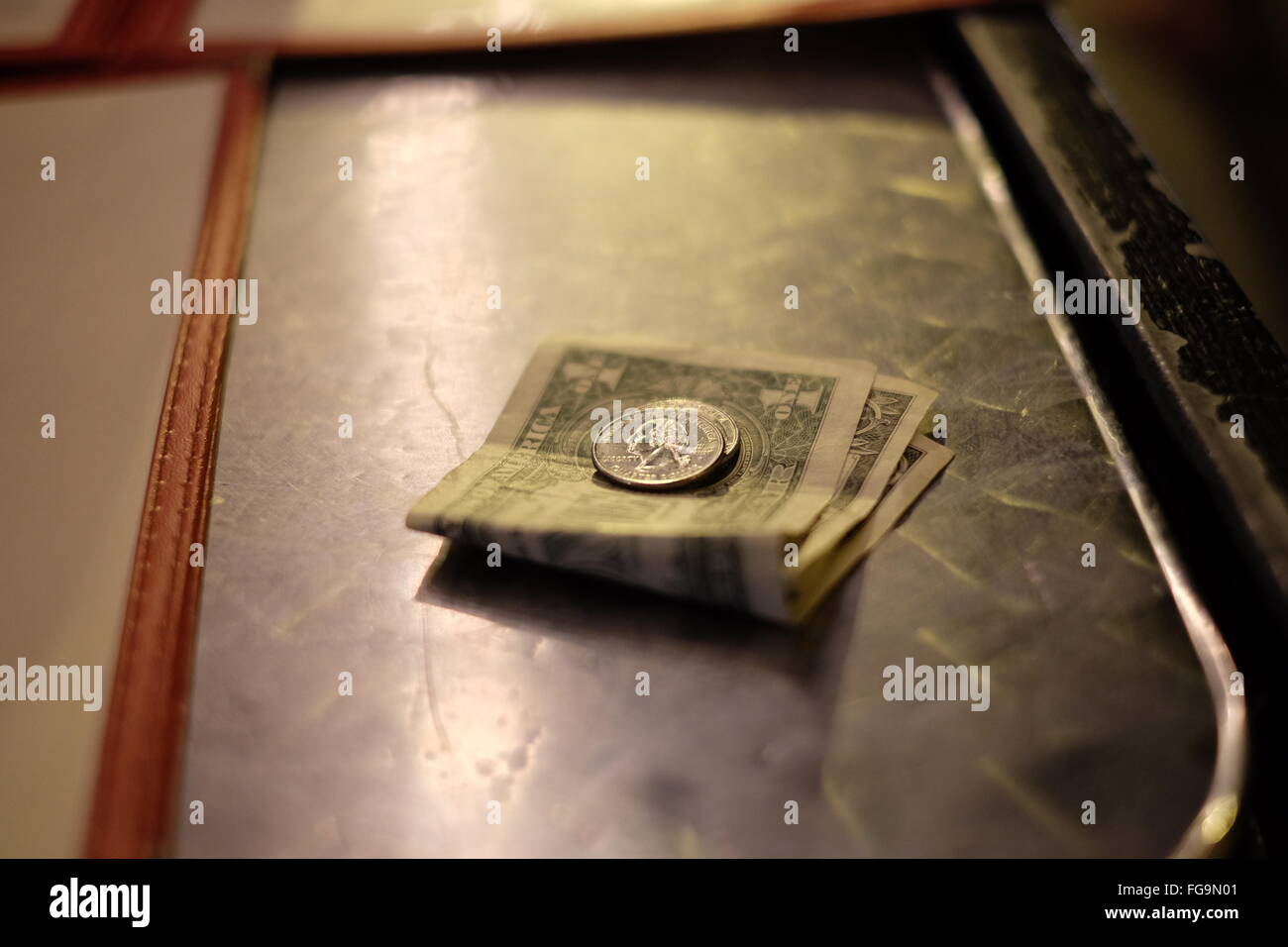 High Angle View Of Us Paper Currency And Coins On Table Stock Photo