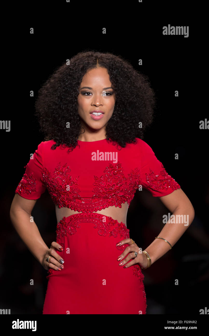 NEW YORK, NY - FEBRUARY 11, 2016: Serayah wearing dress by Reem Acra walks runway for the Heart Truth Red Dress Collection 2016 fashion show at Moynihan Station Stock Photo