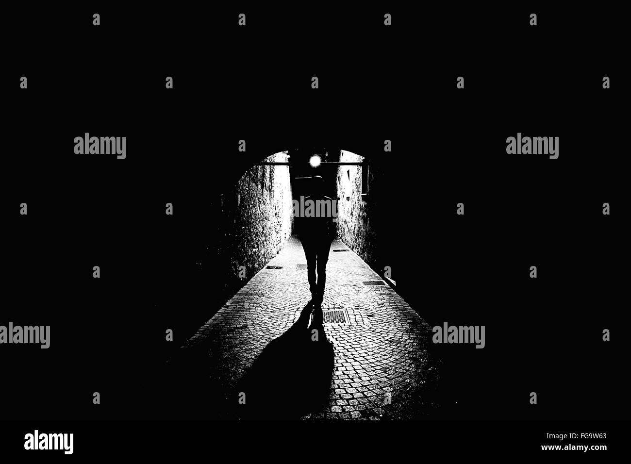 Person Walking In Tunnel Stock Photo