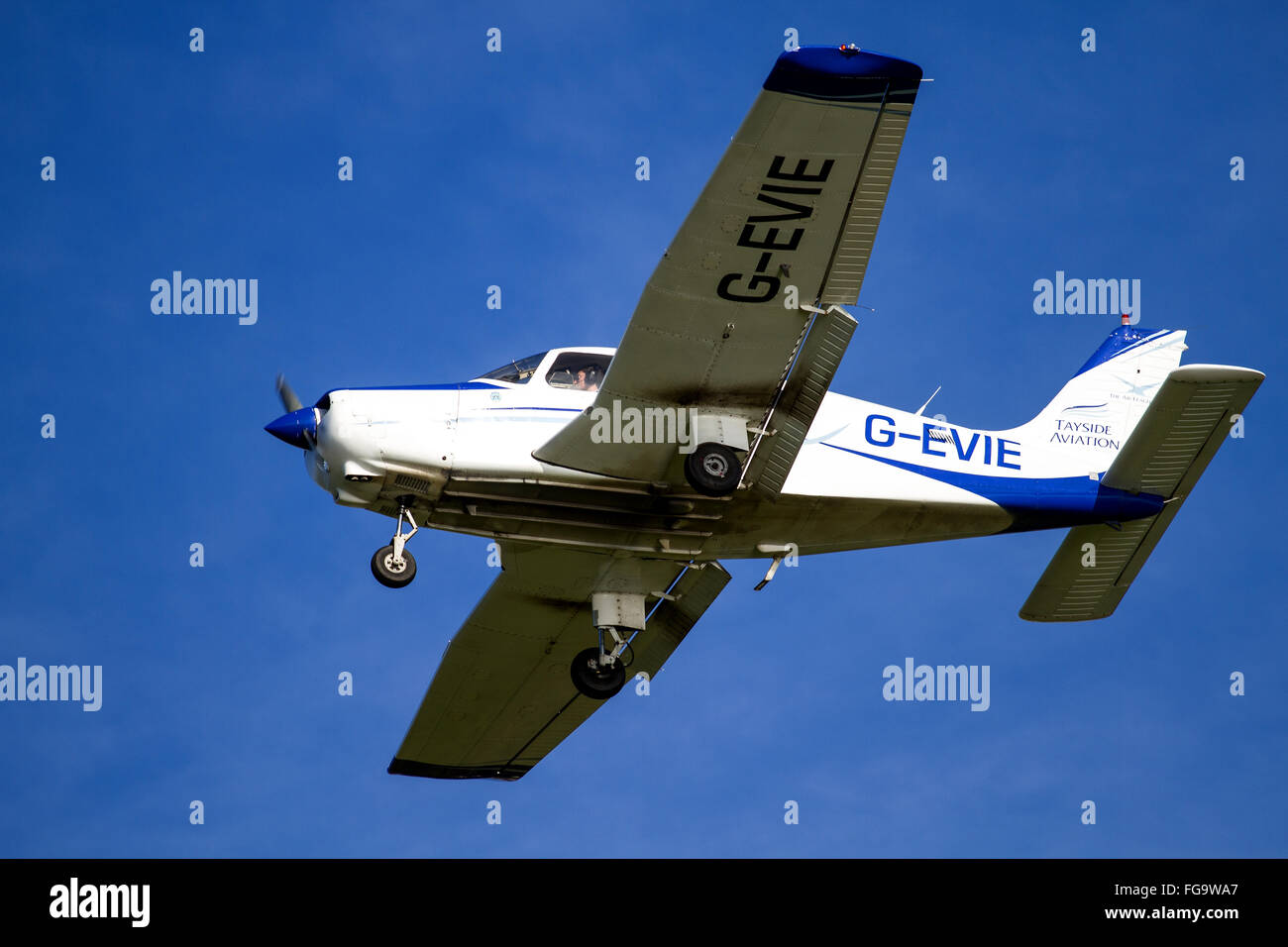 Tayside Aviation Piper PA-28 Warrior G-EVIE light aircraft flying overhead while preparing to land at the airport in Dundee, UK Stock Photo