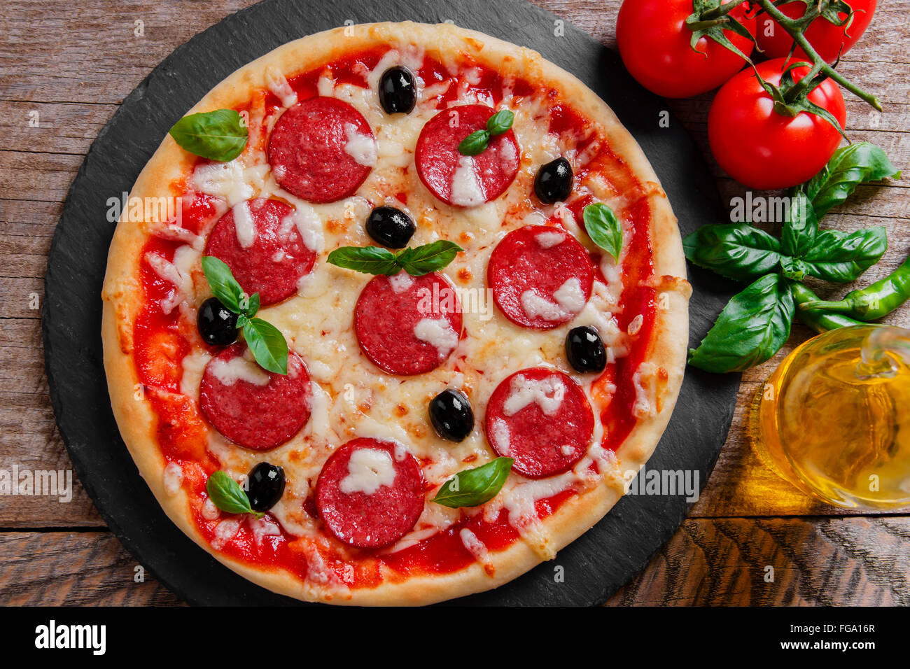 pizza with salami tomato and cheese Stock Photo Alamy