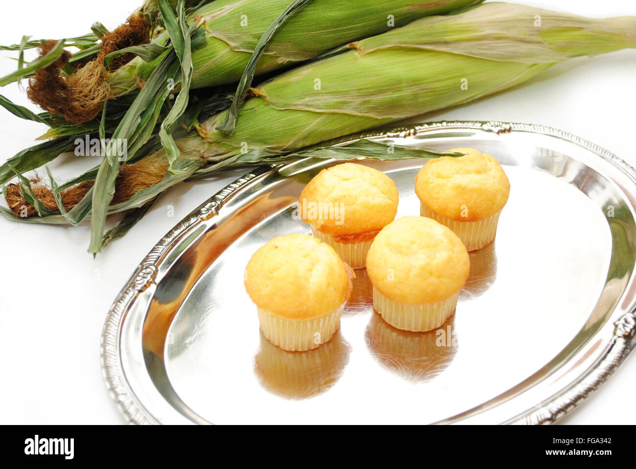 Four Delicious Corn Muffins on a Silver Platter Stock Photo