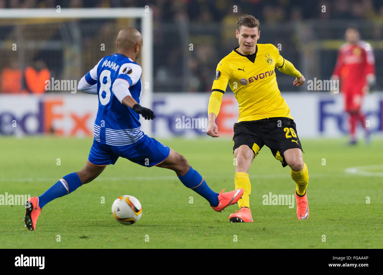 Dortmund's Lukasz Piszczek (r) and Porto's Yacine Brahimi (l) fighting for the ball during the UEFA Europa League knockout match between Borussia Dortmund and FC Porto in the Signal Iduna Park in Dortmund, Germany, 18 February 2016. PHOTO: GUIDO KIRCHNER/dpa Stock Photo