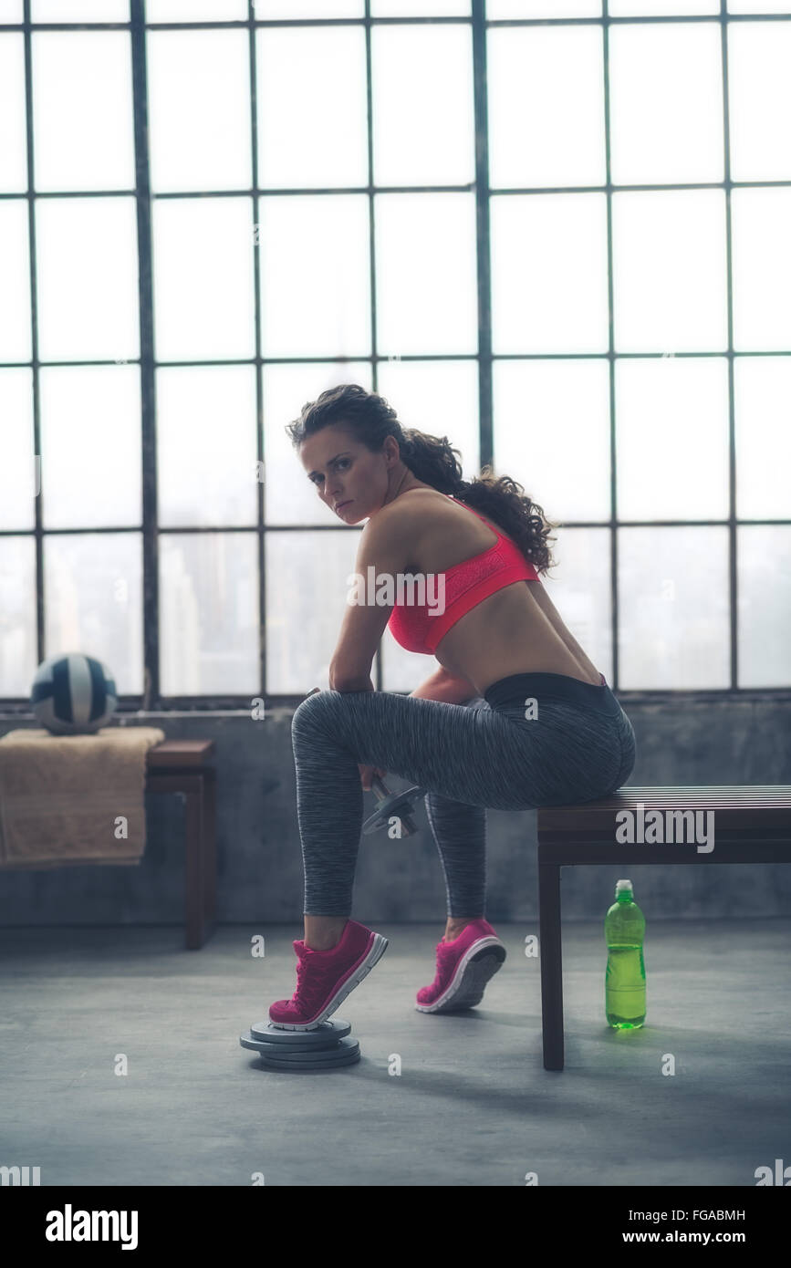 Body and mind workout in loft fitness studio. Fitness woman with