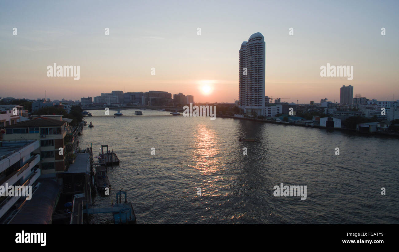 A aerial view above the Chao Phraya River at sunset in Bangkok ...