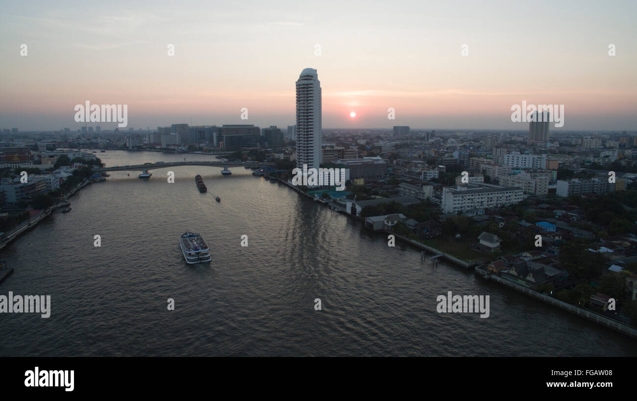 A aerial view above the Chao Phraya River at sunset in Bangkok ...