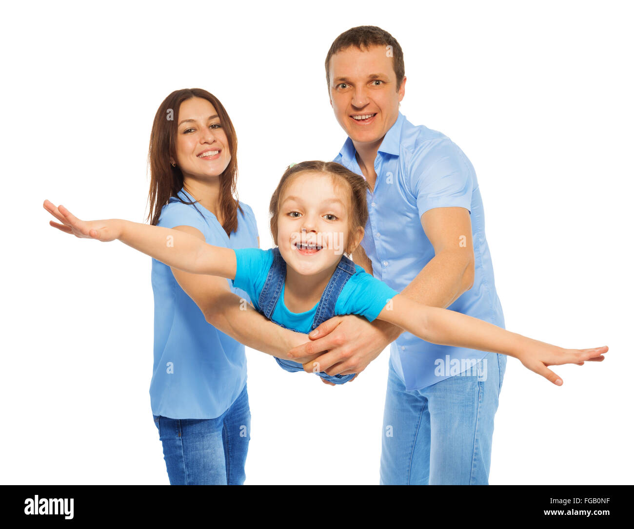 Girl like little plane flying from parents hands Stock Photo