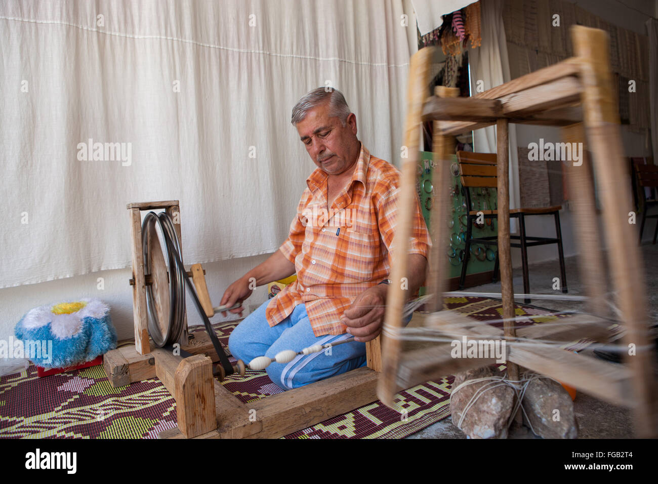 A man spinning spools of cotton on a loom, Turkey Stock Photo