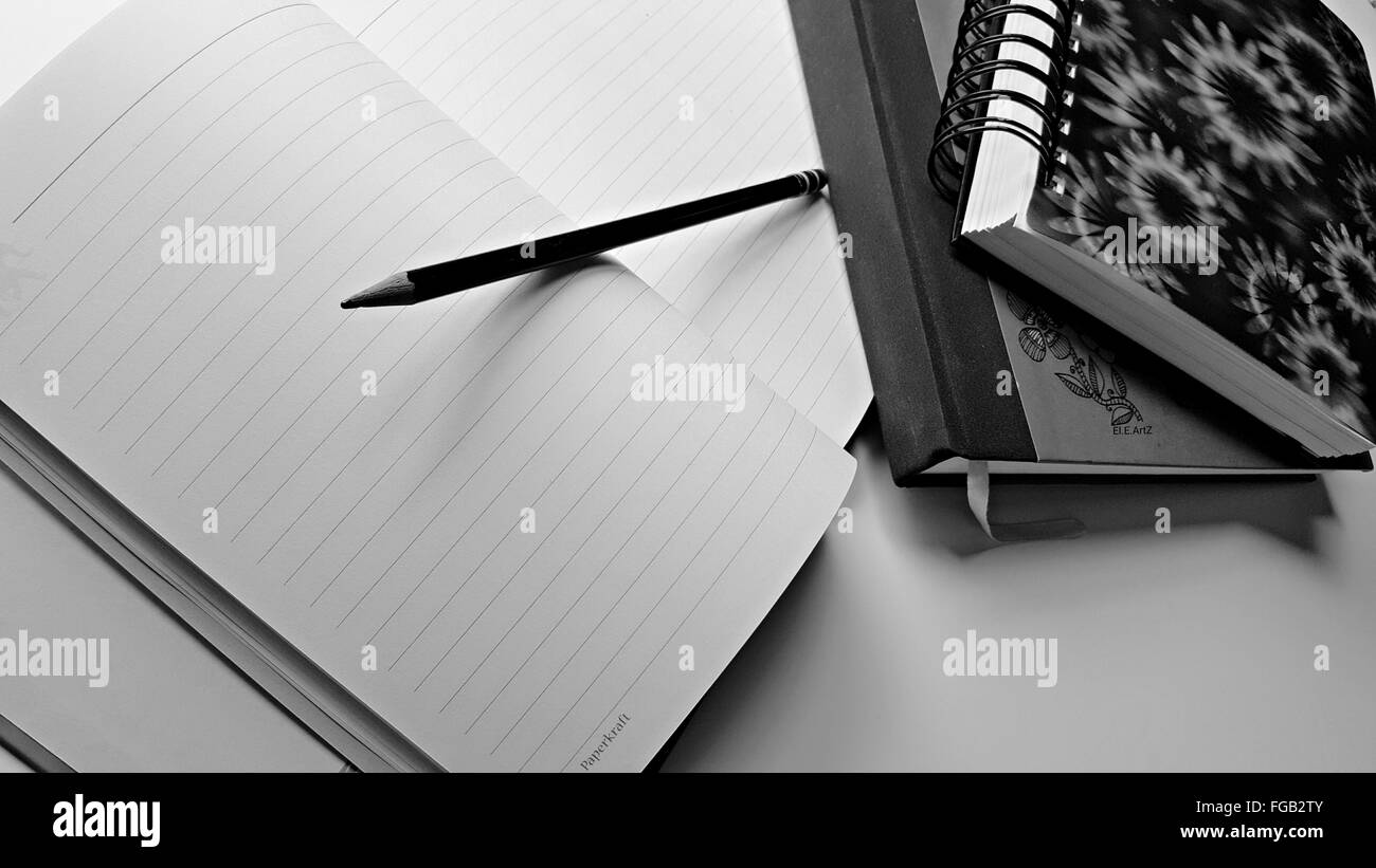 High Angle View Of Notepads With Pencil On Table Stock Photo