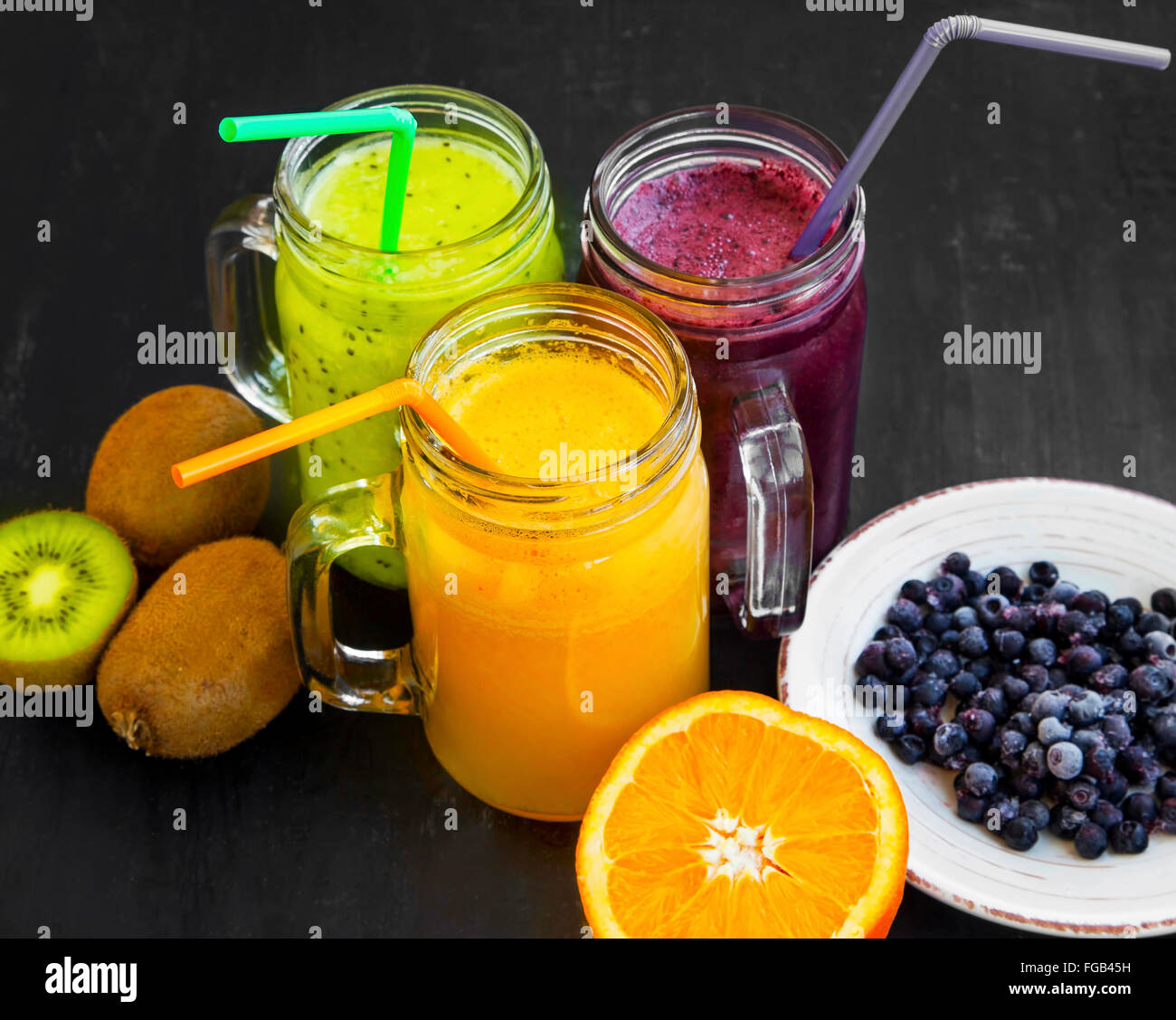 Healthy fruit juices with green kiwi,blueberries and orange Stock Photo