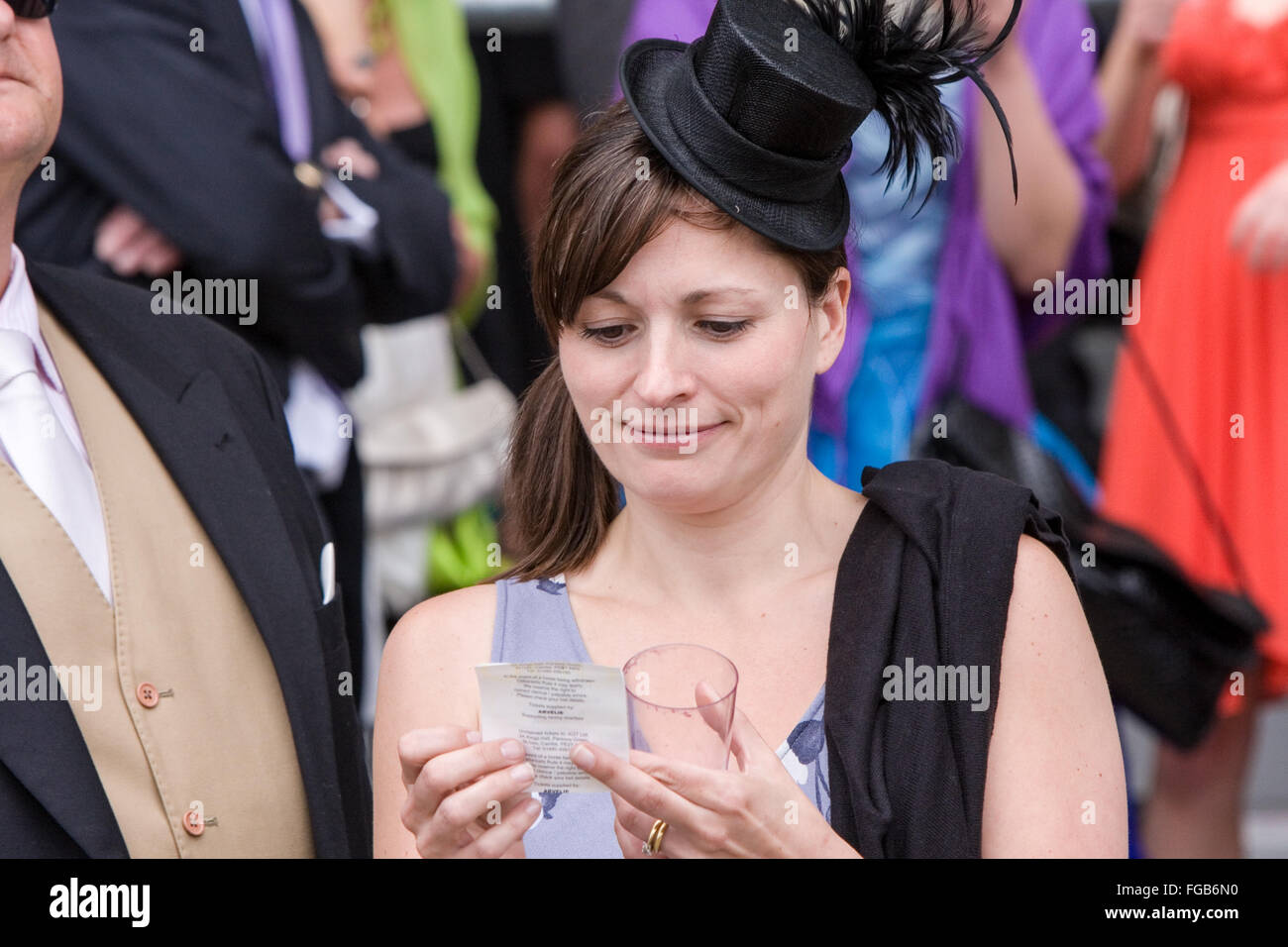 woman,in,hat,betting,slip,slips,betting slip,betting slips,Royal Ascot, horse, race, meeting,Ascot,Berkshire,England,GB,British,English,U.K. Europe. Stock Photo