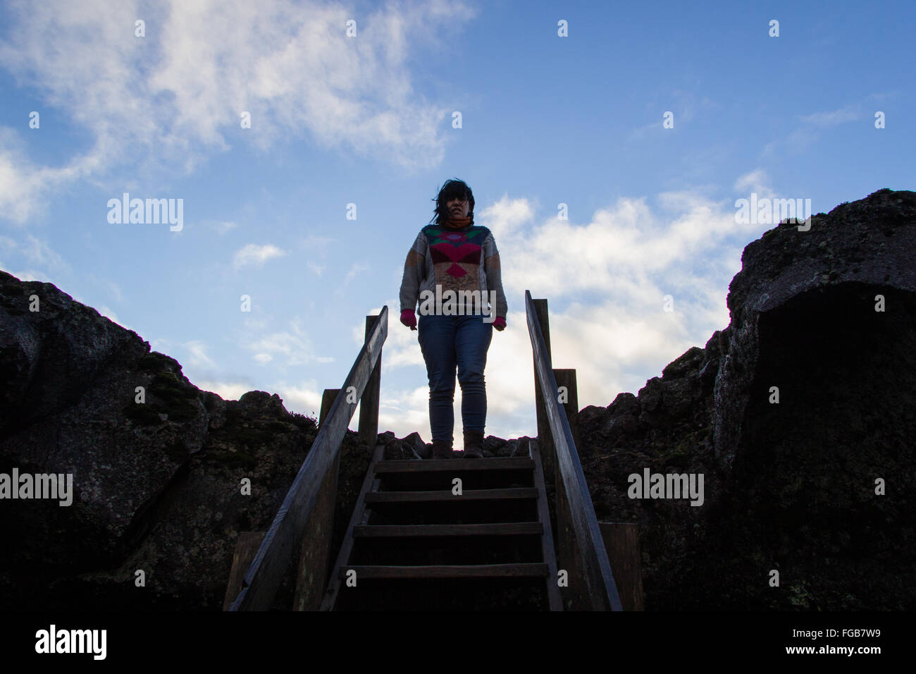 A woman waiting on the entrance of a lava tube in Iceland, near the Blue Lagoon Stock Photo