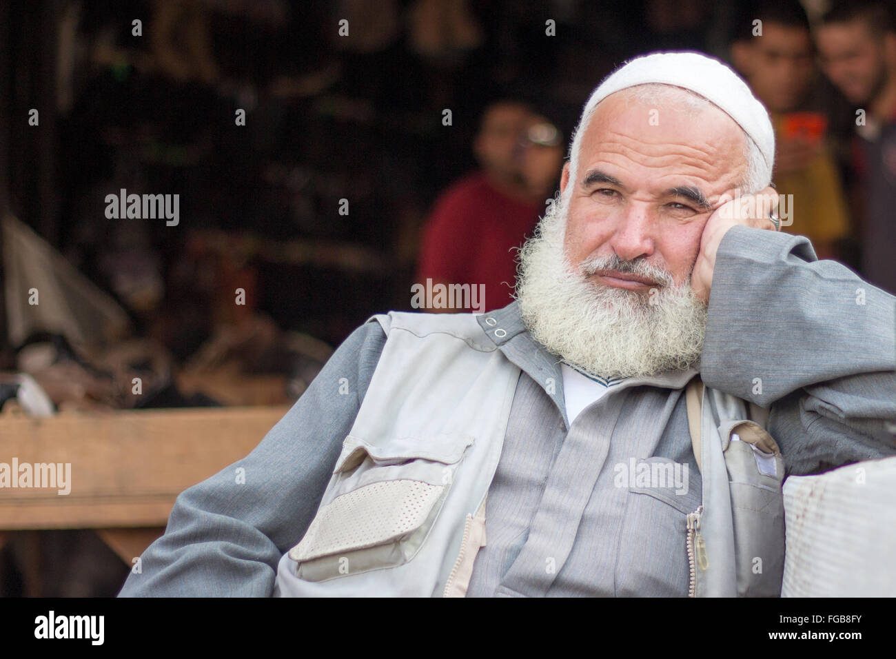 Thoughtful Muslim Man Looking Away While Sitting Stock Photo