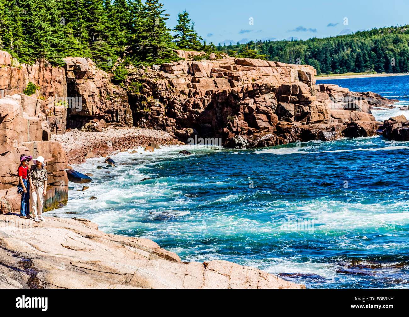 Two Asian Women on rocks in Acadia National Park near Bar Harbor, Maine ...