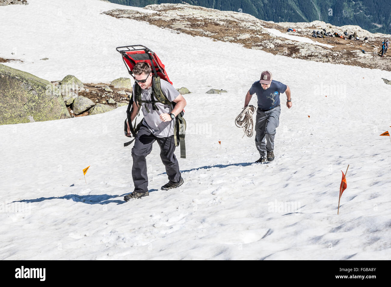 Two people training for an emergency evacuation by sledge in the French alps Stock Photo