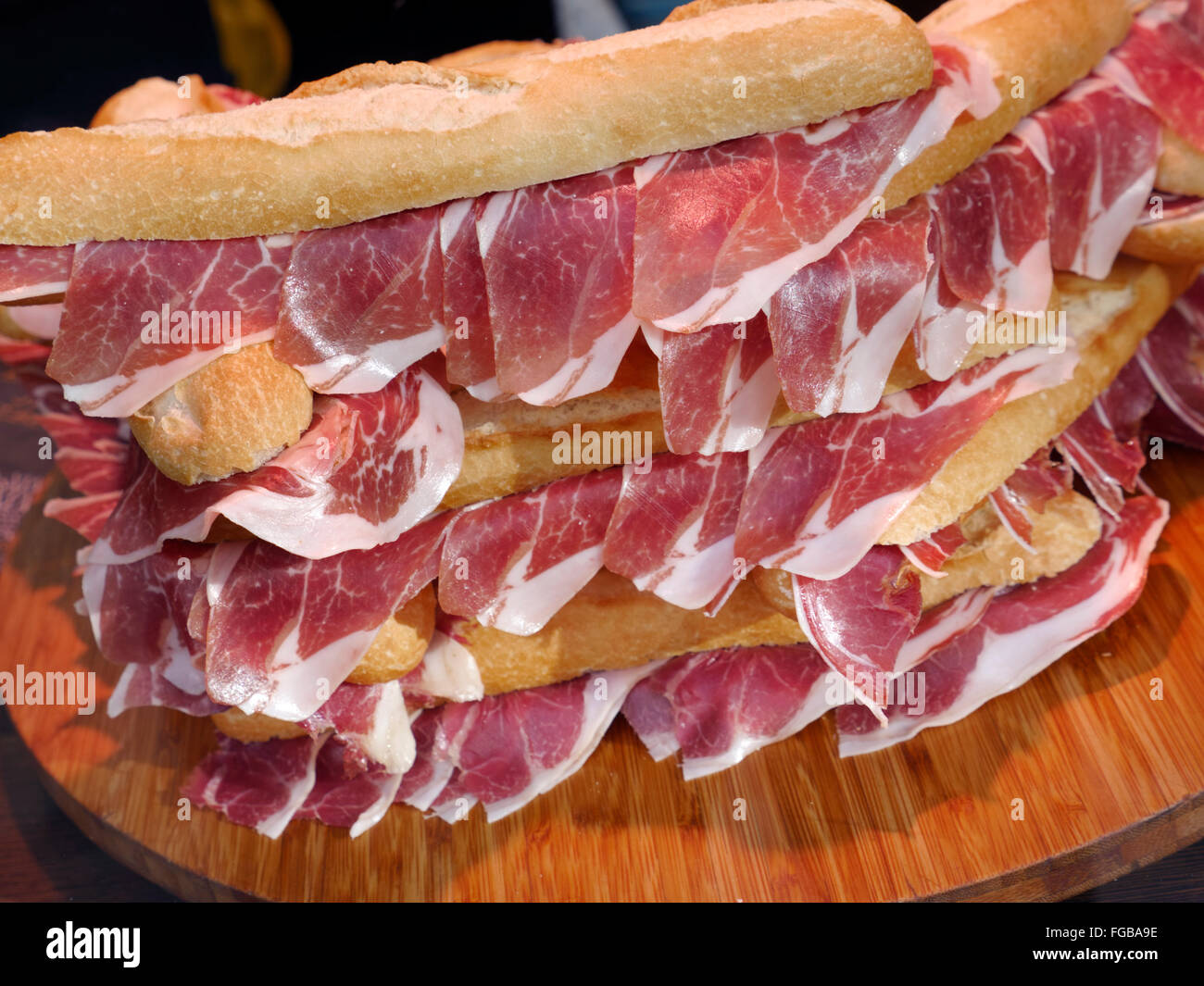 Freshly made stack of Jamón serrano Spanish ham baguette sandwiches on display for sale in London delicatessen Stock Photo