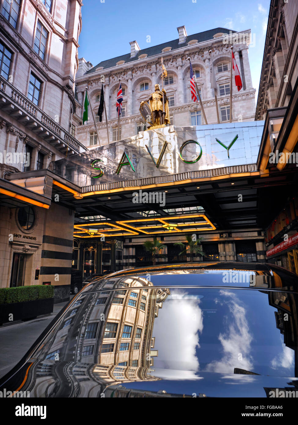 SAVOY HOTEL Exterior view of luxury Five-Star Savoy Hotel entrance foyer with sky reflection in Rolls Royce motorcar The Strand London WC2 Stock Photo