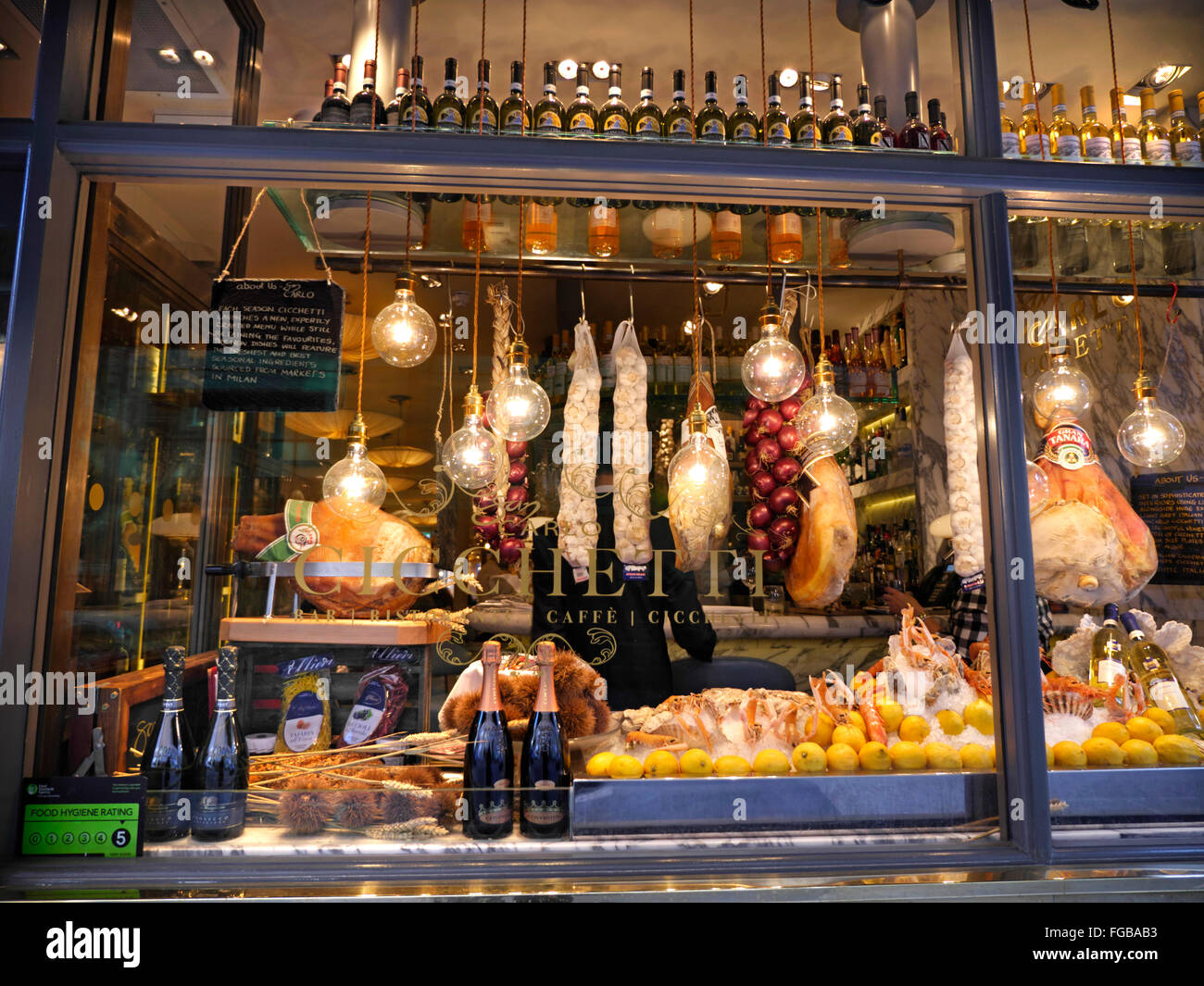 San Carlo Cicchetti Italian 'tapas' style restaurant lit window display at dusk in Covent Garden London UK Stock Photo