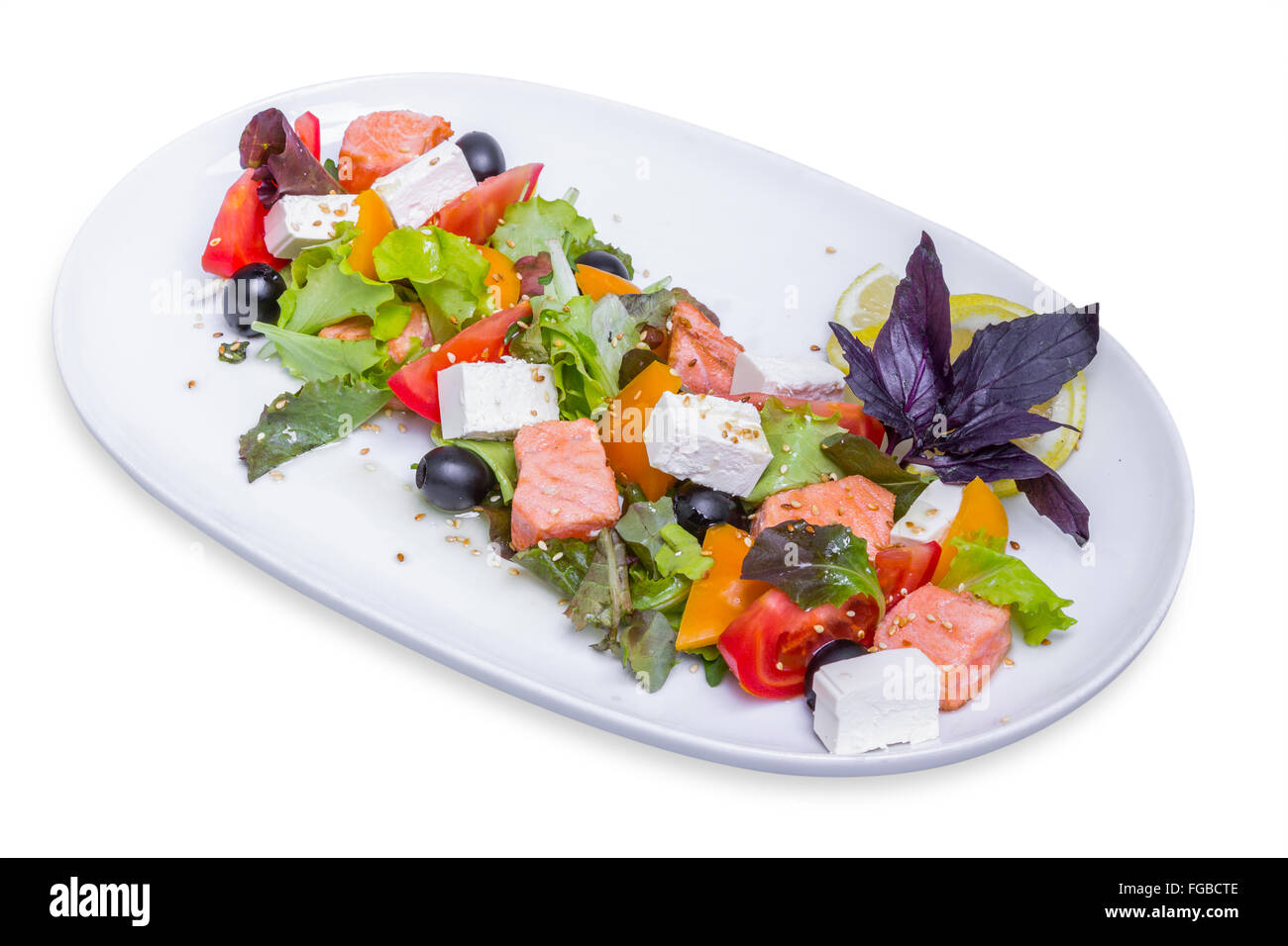 Salmon salad with feta cheese on white long plate, isolated with clipping path Stock Photo