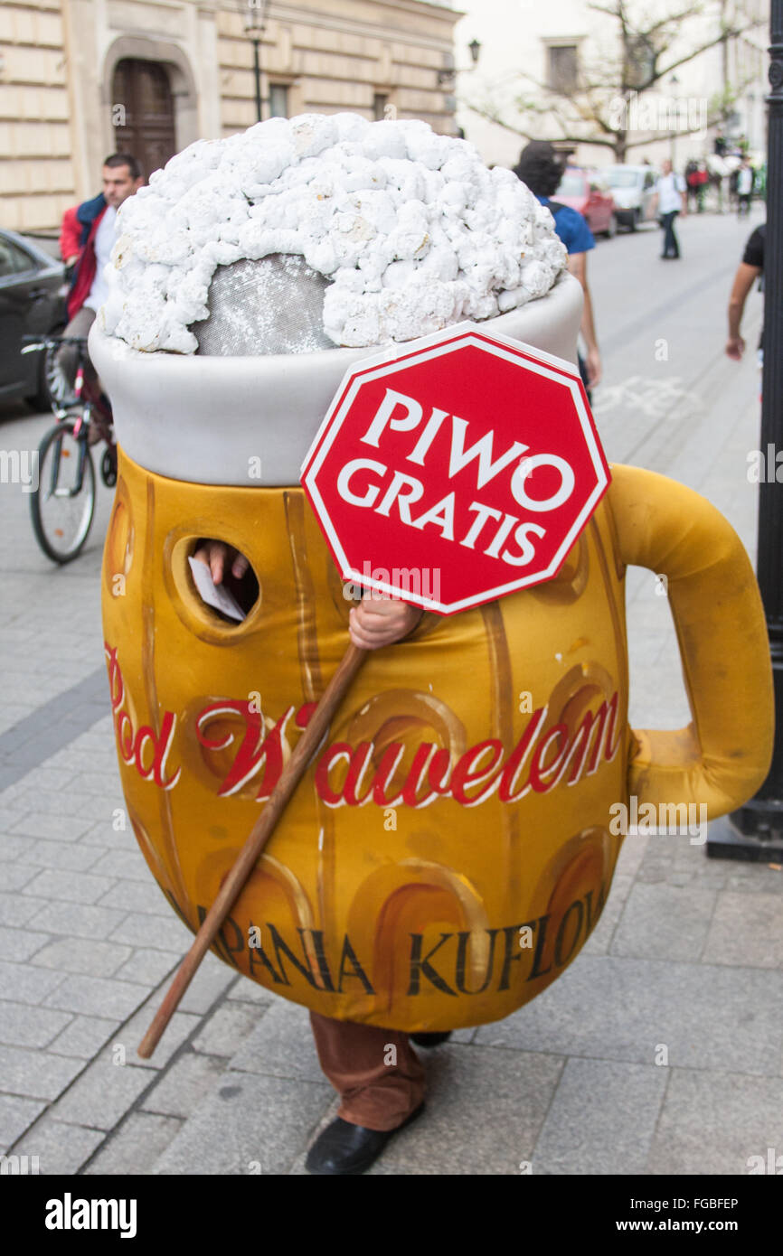 Local dressed as a jug of beer with free beer sign handing out coupons for free beer in Old Town of Krakow,Poland,Europe. Stock Photo