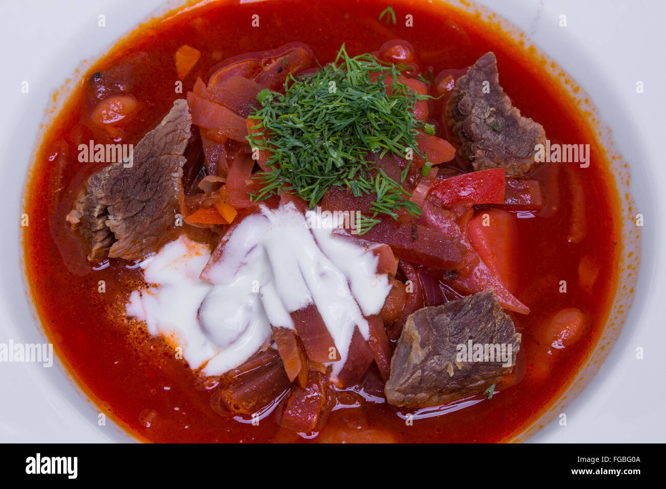 East European cuisine. Ukrainian red soup borscht with sour cream ...
