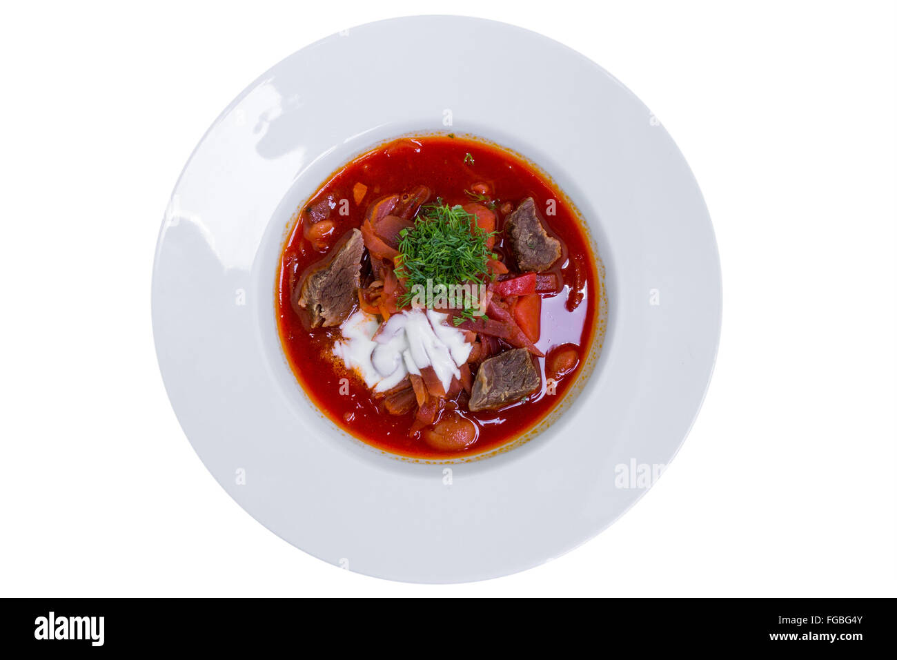 East European cuisine. Ukrainian red soup borscht with sour cream, top view, isolated Stock Photo