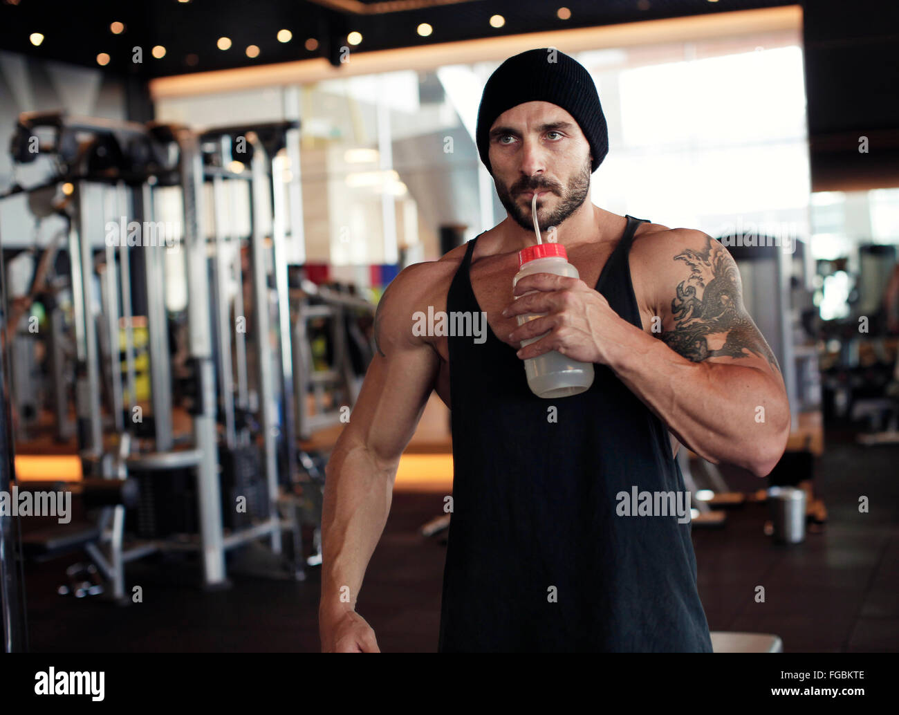 Muscular man drinking water Stock Photo - Alamy