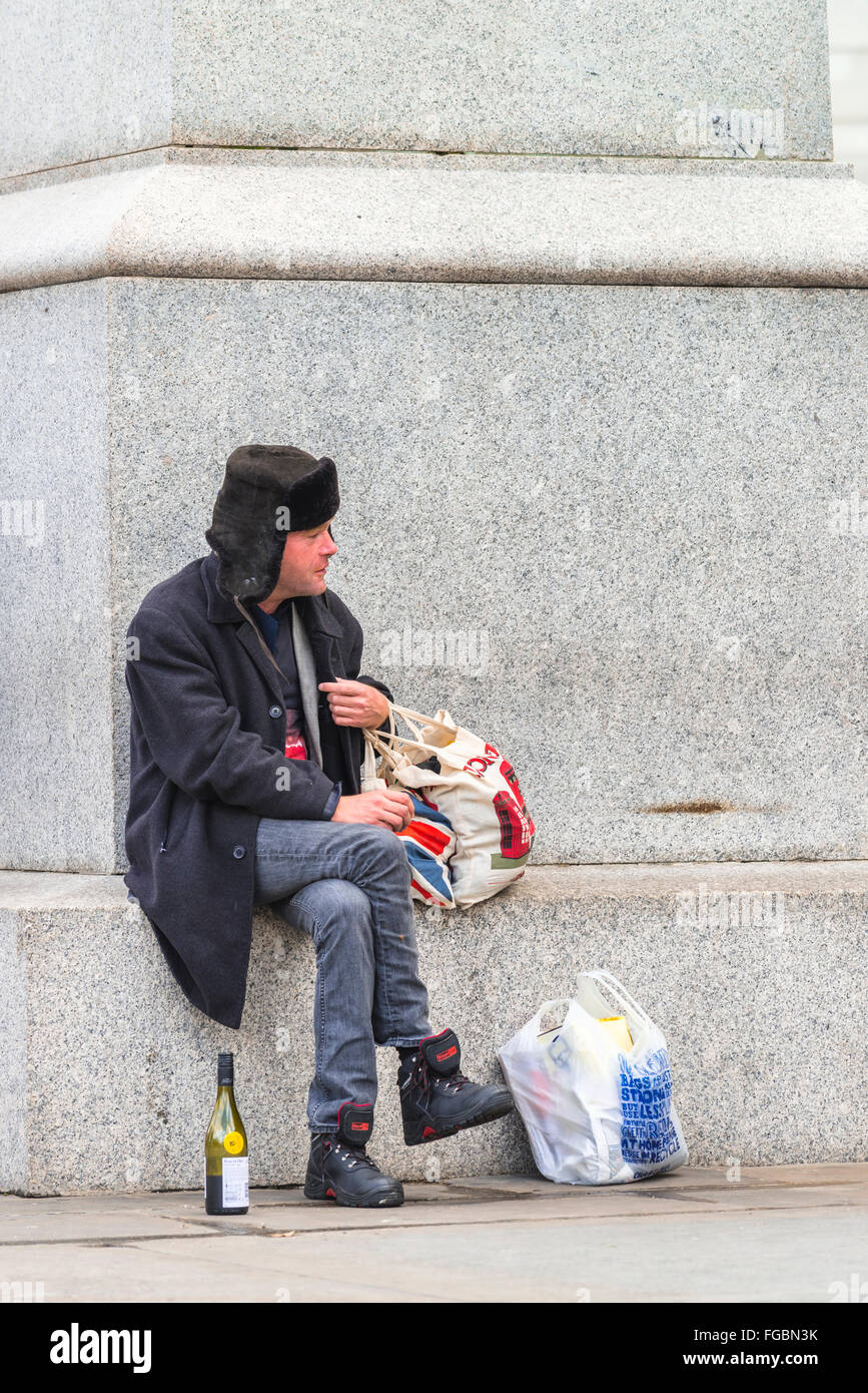 Homeless man eat and drinking at the town Stock Photo Alamy