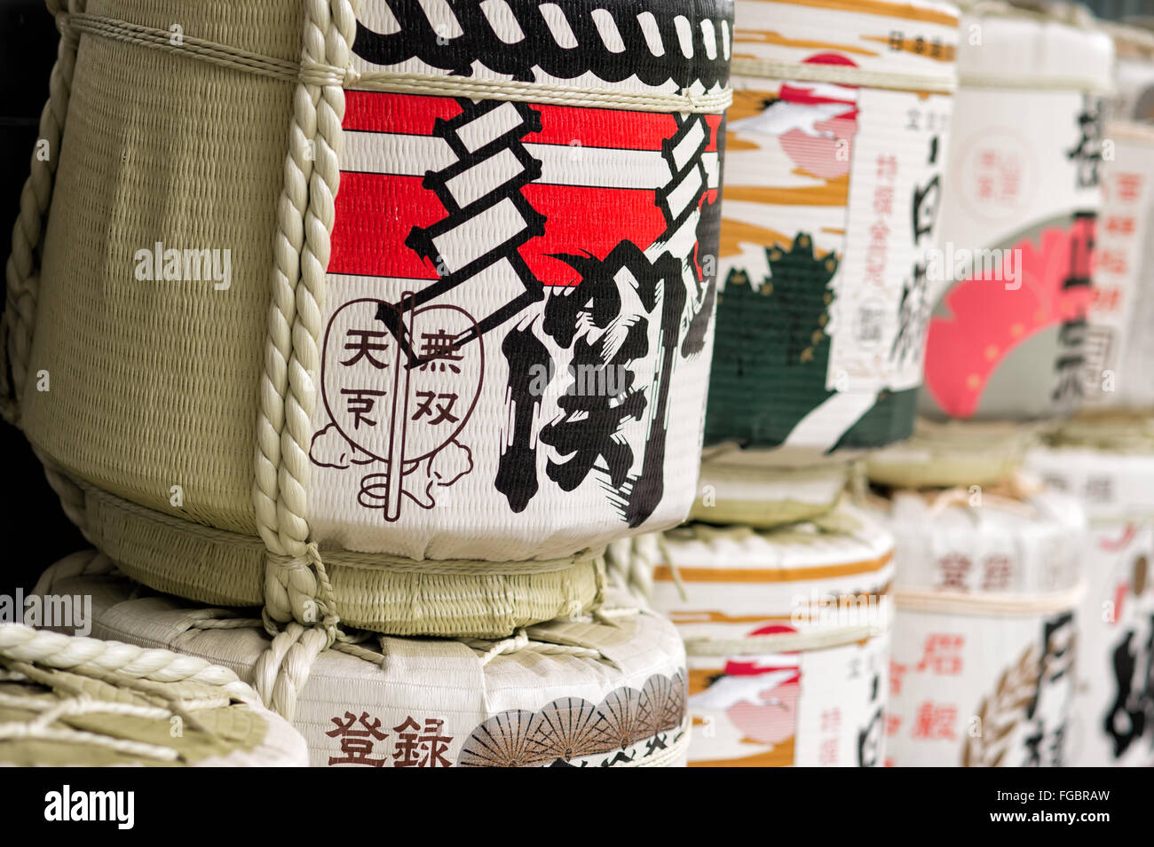 Assorted traditional Japanese sake barrels with intricate designs, showcasing cultural symbolism. Stock Photo