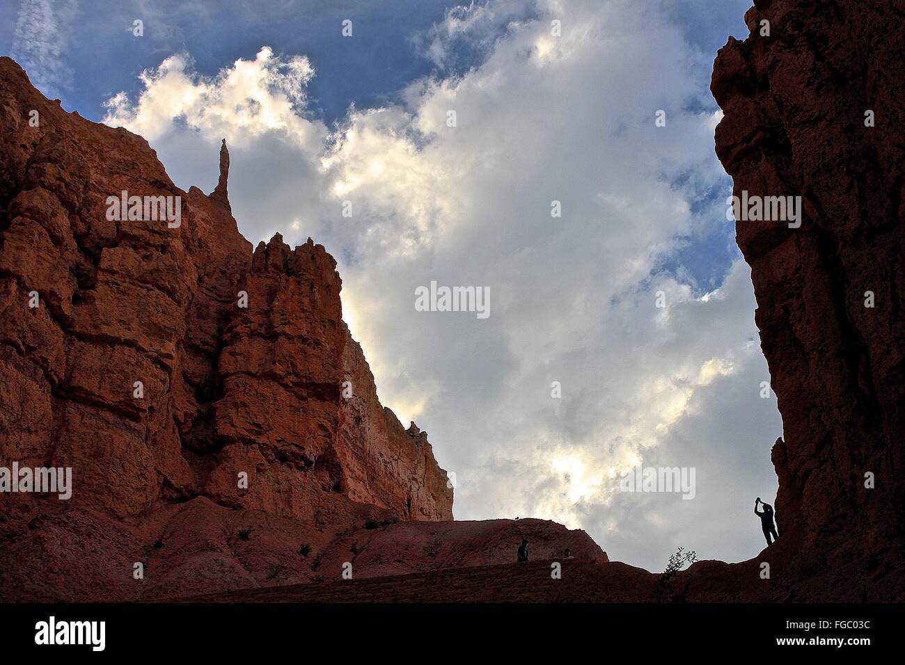 Low Angle View Of Rocky Mountains Against Cloudy Sky Stock Photo