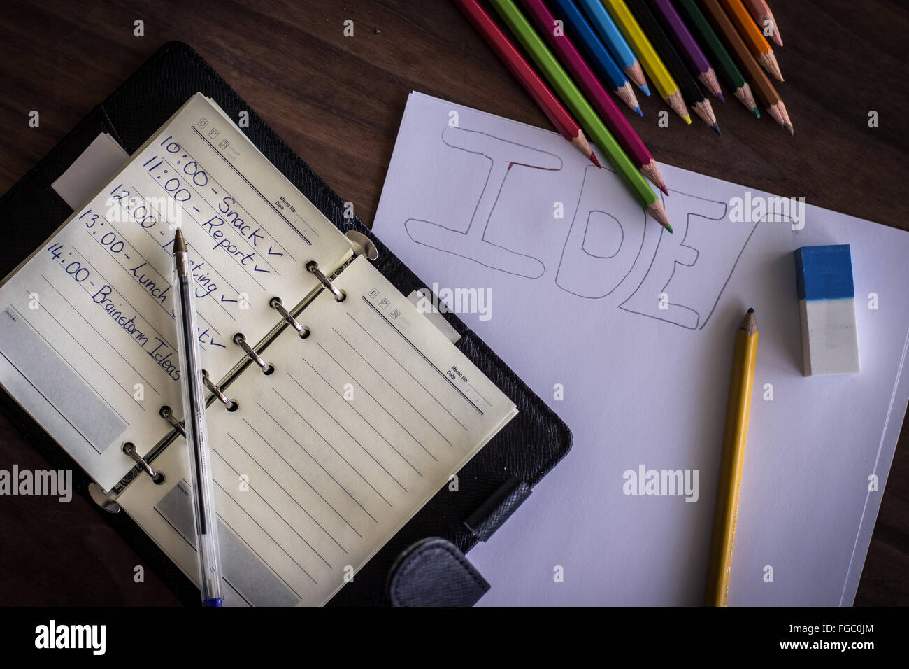 High Angle View Of Personal Organizer With Colored Pencils On Table Stock Photo