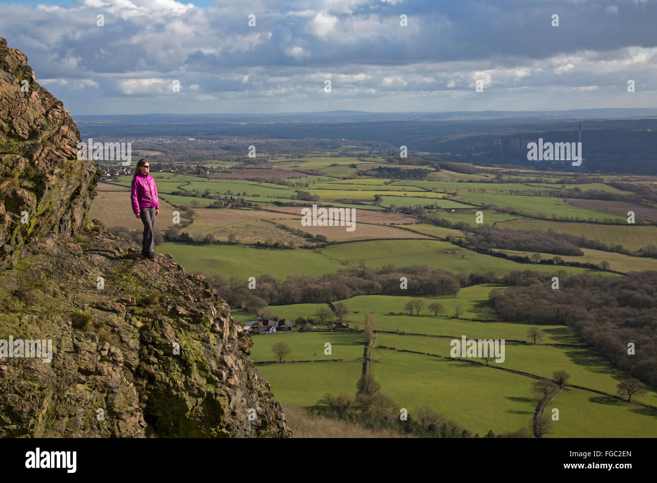 Woman on the Wrekin hill in Shropshire, England. Cooling towers of the Ironbridge Power station in the far distance. Stock Photo