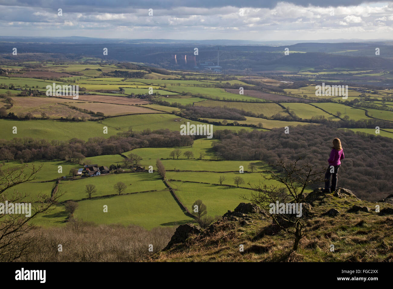 Woman looking towards Ironbridge, from the top of the Wrekin hill in Shropshire, England. Stock Photo