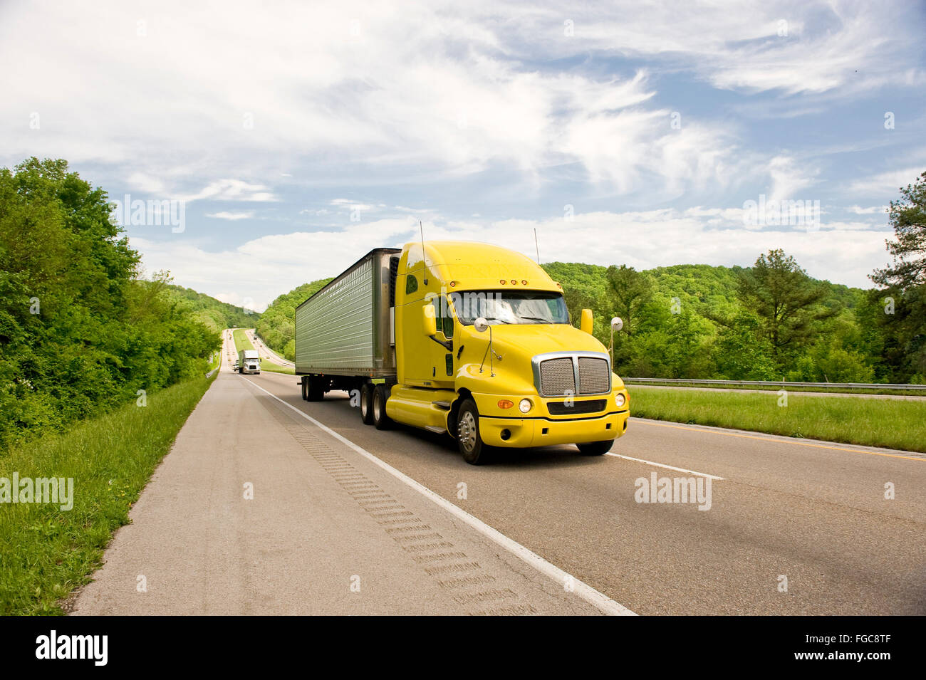 Yellow Semi Truck Travels On Interstate In Springtime Stock Photo Alamy