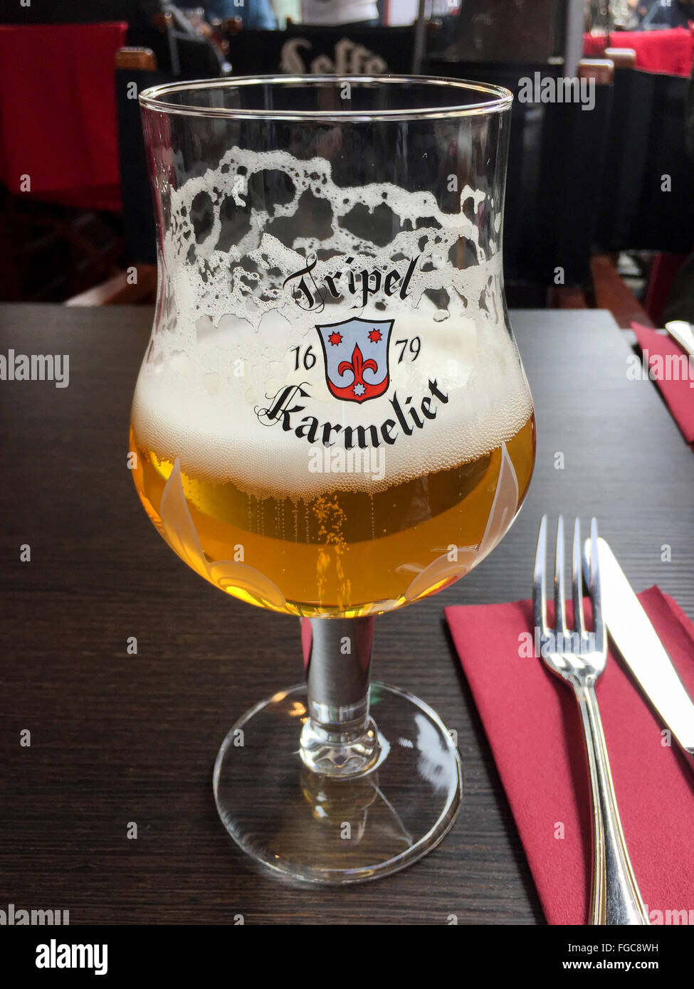 Glass of Tripel Karmeliet Belgian pale ale beer. Stock Photo