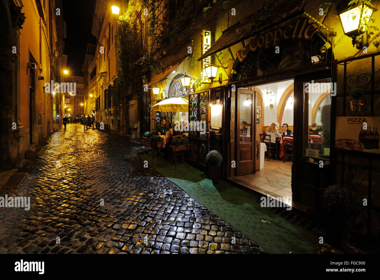 restaurant in a narrow cobbled street in Rome, Italy Stock Photo