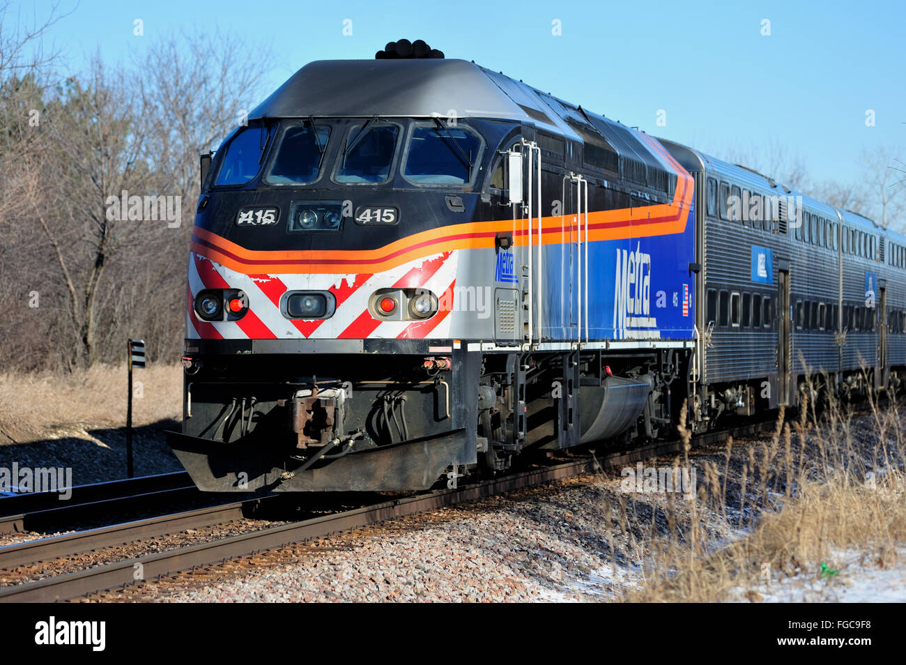 An inbound Metra commuter train leaving Bartlett, Illinois in suburban Chicago. Bartlett, Illinois, USA. Stock Photo