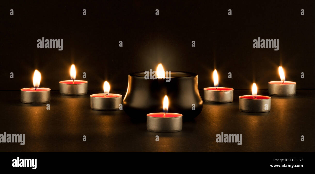 Group of burning candles on black background Stock Photo - Alamy
