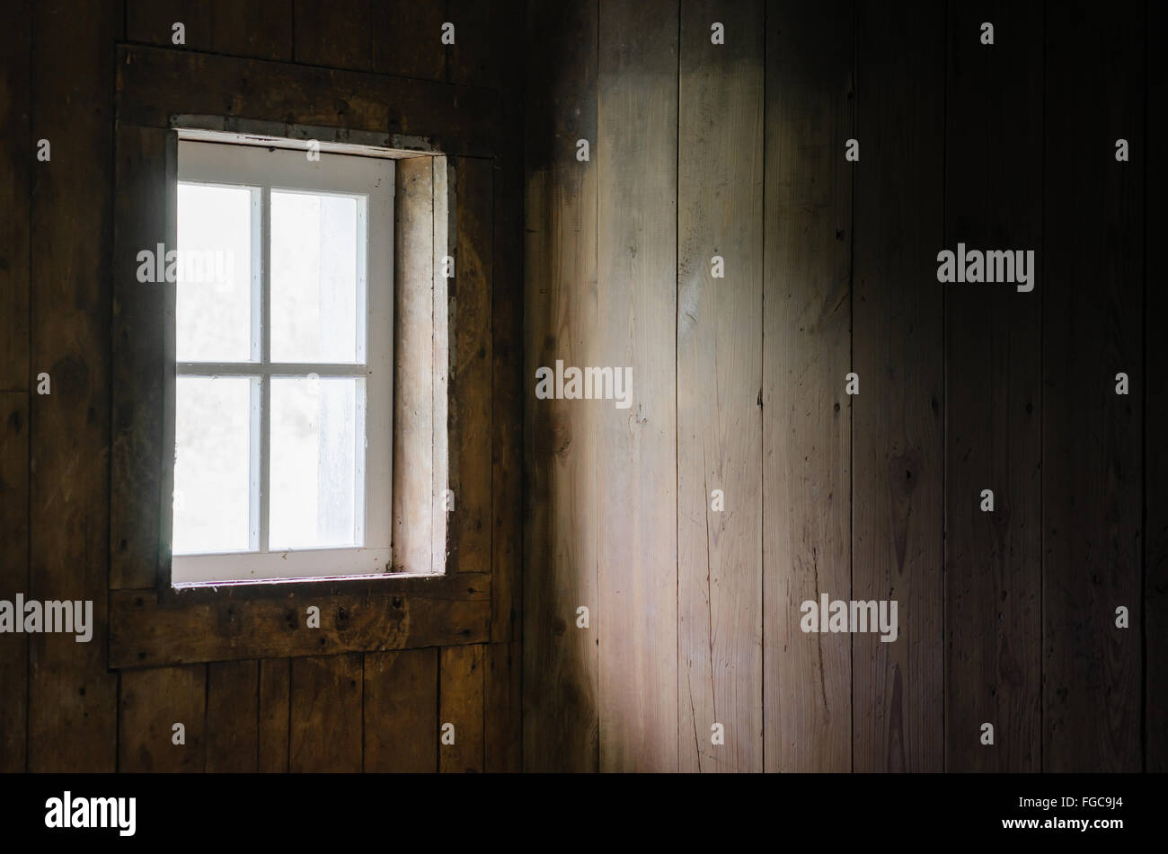 Soft Natural Light coming through Barn window to brighten Barn Board Interior. Stock Photo