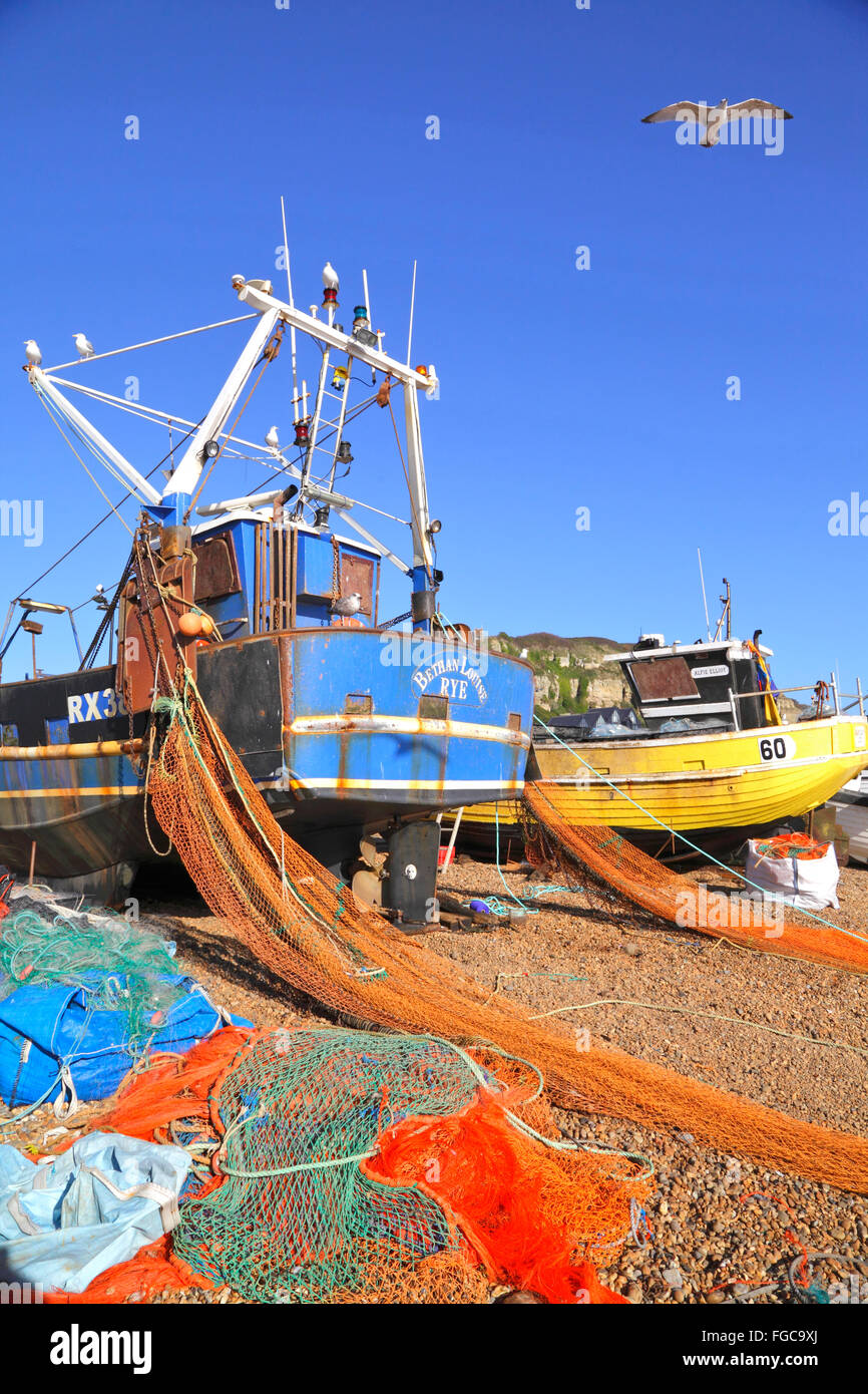Hastings UK. Colourful nets and fishing boats on the Hastings Stade fishermen's beach, Hastings, East Sussex, England, GB, Stock Photo