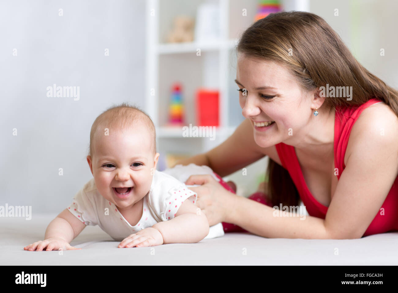 Happy cheerful family. Mother and baby playing, laughing and hugging Stock Photo