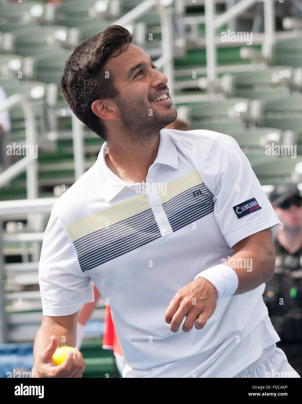 Delray Beach, Florida, US. 18th Feb, 2016. TREAT HUEY, Filipino-American pro tennis player, prepares to throw a tennis ball to the fans after the Filipino-Belarusian third seed duo TREAT HUEY and MAX MIRNYI won through to the ATP World Tour Delray Beach Open semi-finals after a 6-3, 6-4 triumph over Australians Chris Guccione and Bernard Tomic. Credit:  Arnold Drapkin/ZUMA Wire/Alamy Live News Stock Photo