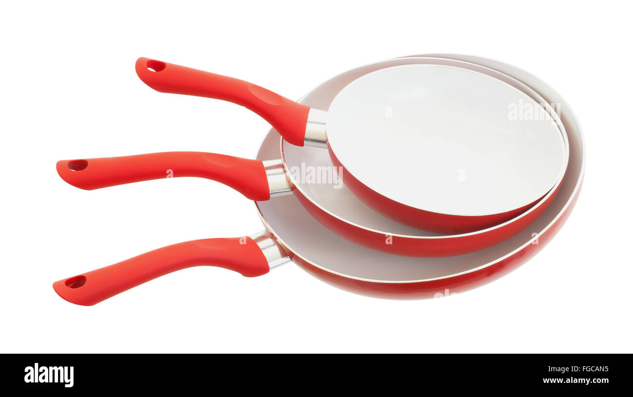 Set of three frying pans, isolated, close-up, red Stock Photo