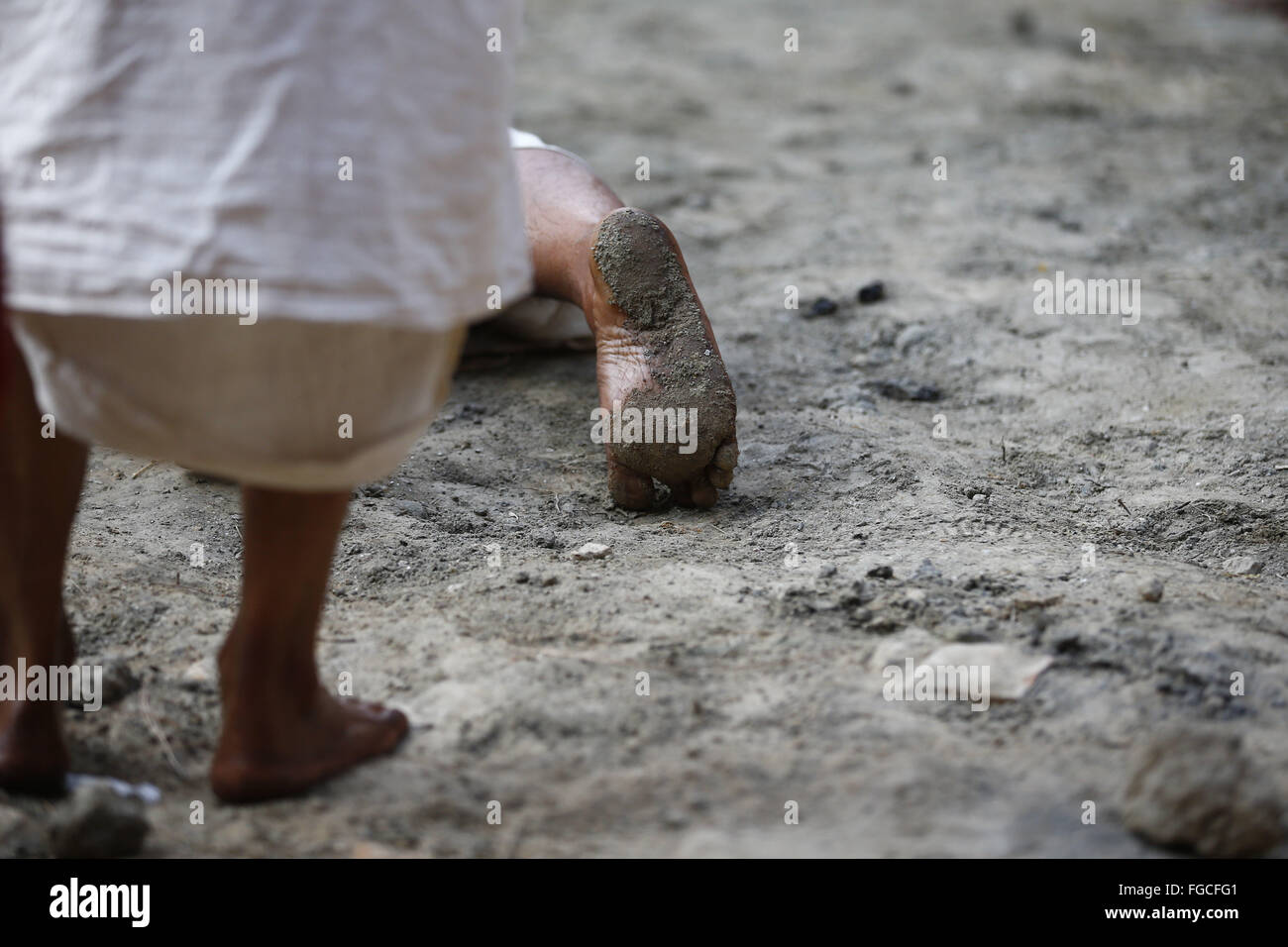 Bhaktapur, Nepal. 19th Feb, 2016. The feet of a Nepalese Hindu devotee man is seen as he reels to offer prayers during the month-long Swasthani Bratakatha festival, devoted to goddess Shree Swasthani in the premise of an ancient Hindu temple of Changu Narayan in Bhaktapur, Nepal on Friday, February 19, 16. Men devotees recite Holy Scripture and women pray for wellbeing of their spouses throughout the month-long fast via travelling barefooted to holy shrines for worship. Credit:  Skanda Gautam/ZUMA Wire/Alamy Live News Stock Photo