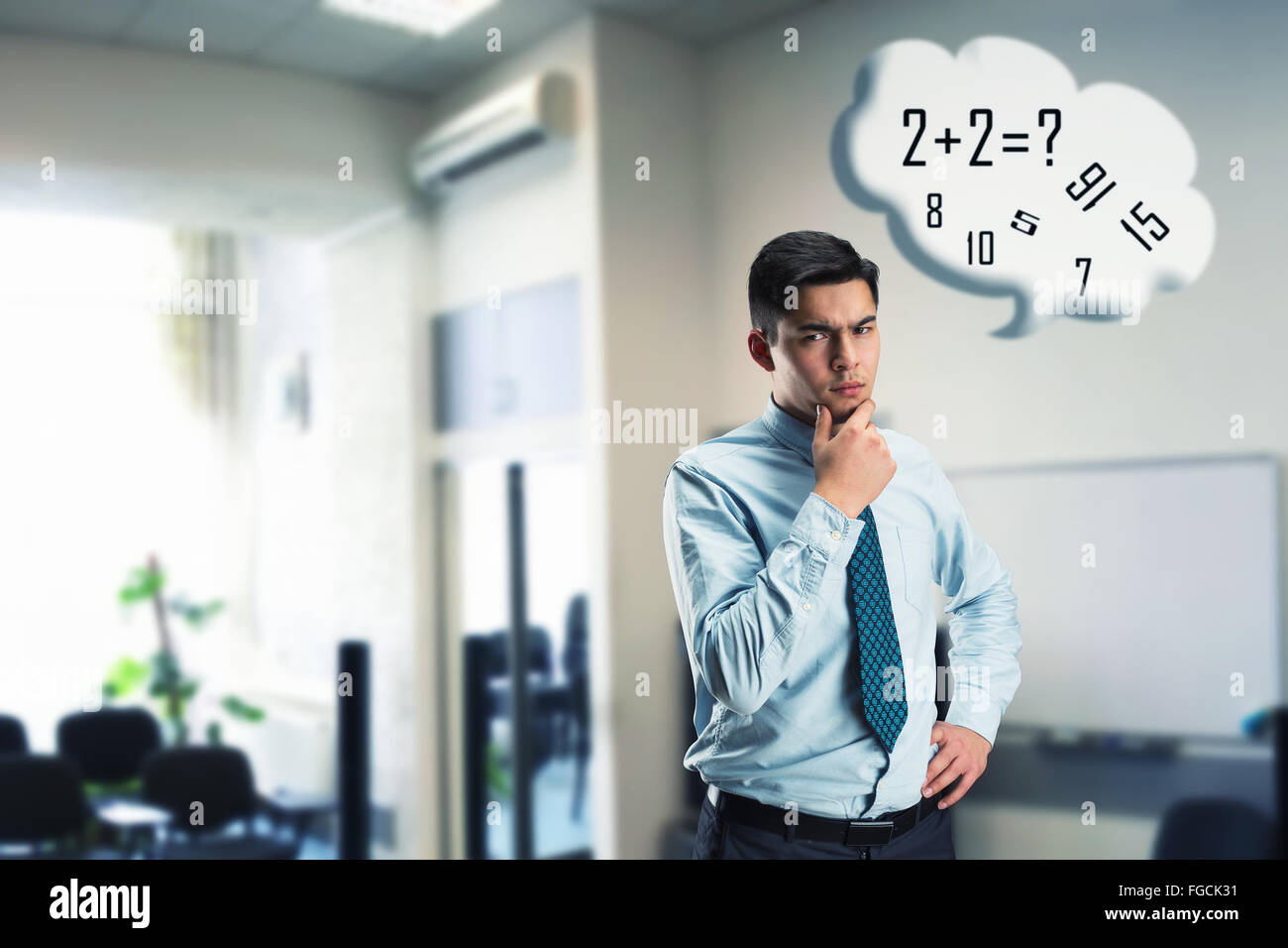 Businessman doing mental arithmetic Stock Photo