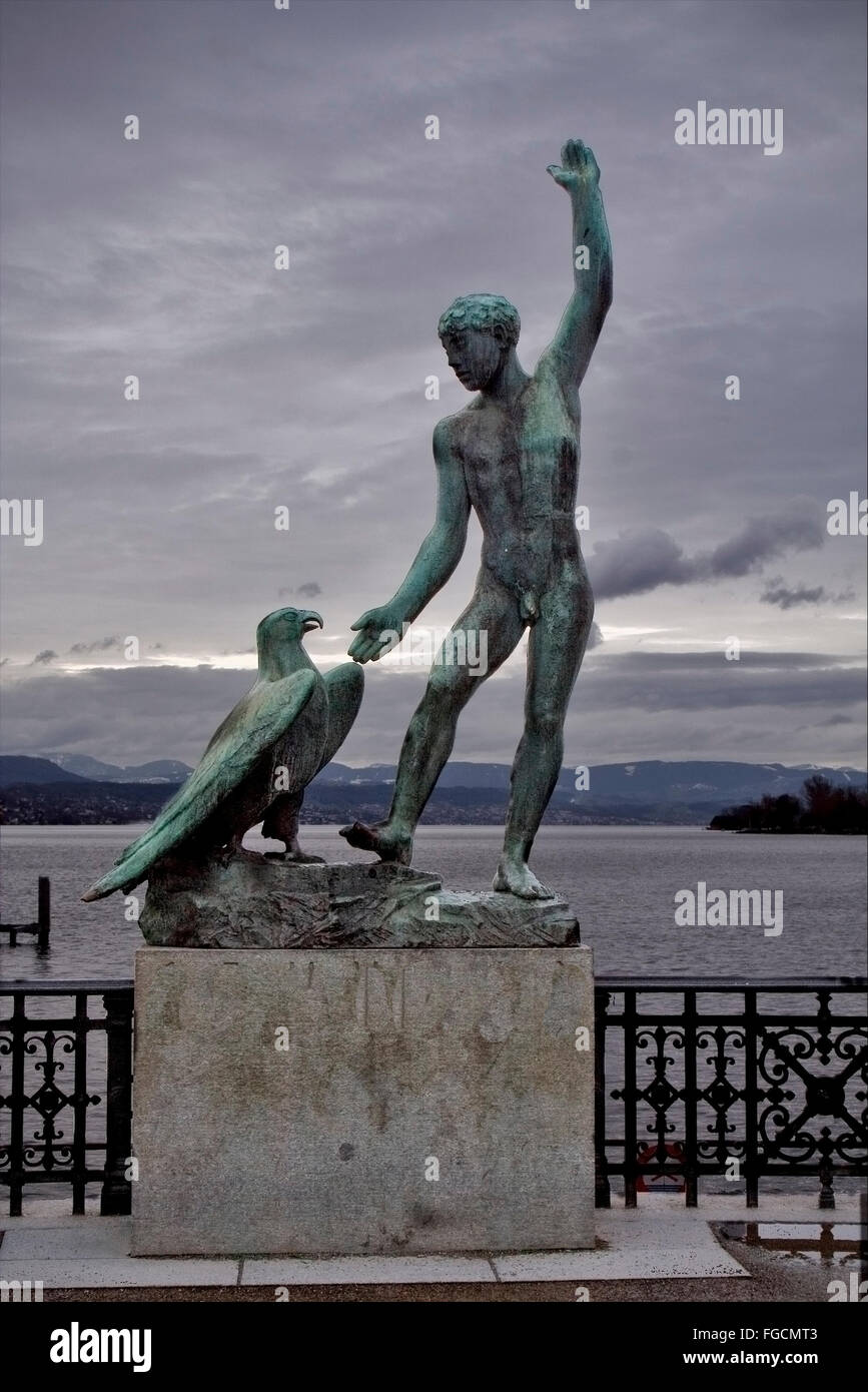 statue of a man and a eagle near the lake of costanza in zurich swisse Stock Photo
